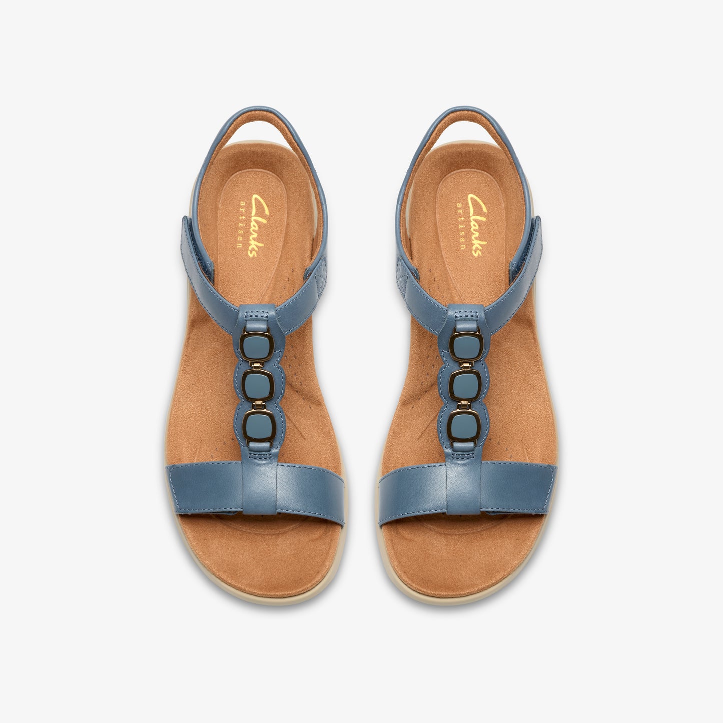 Two blue sandals with gold accents on a light brown sole, viewed from above.