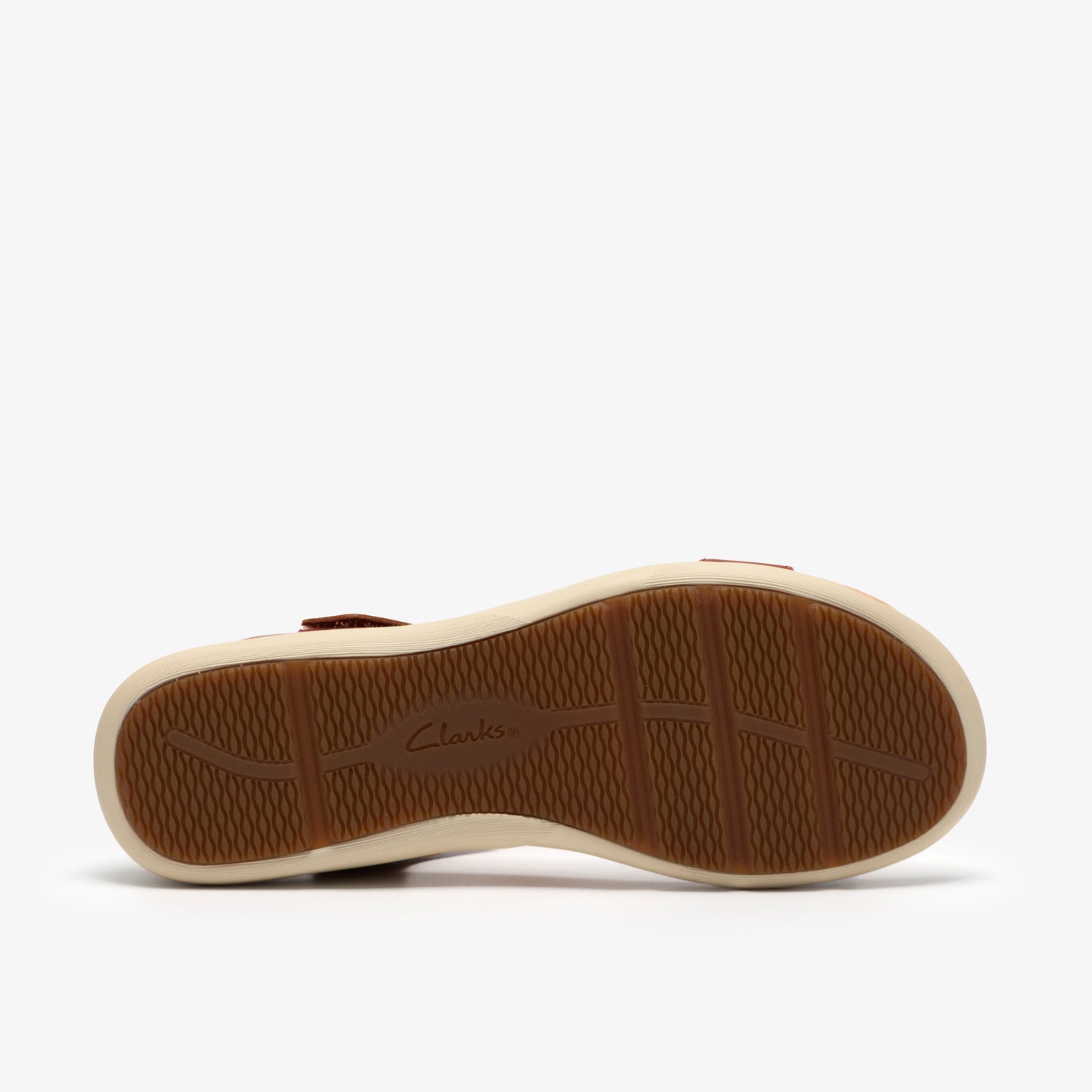 Underside of brown sandal featuring ridged rubber sole with the word "Clarks" printed in script