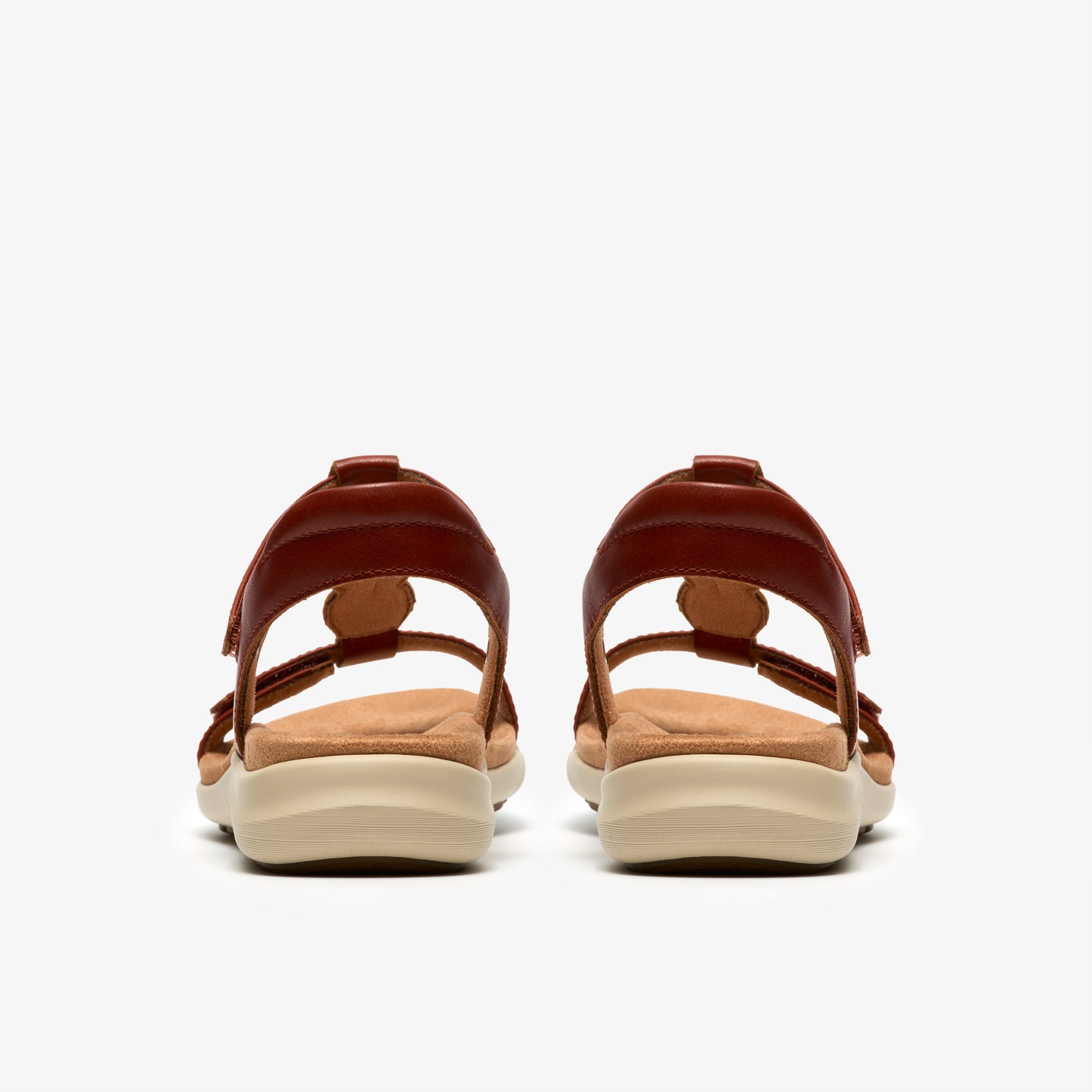 Rear view of brown sandals with tan soles.