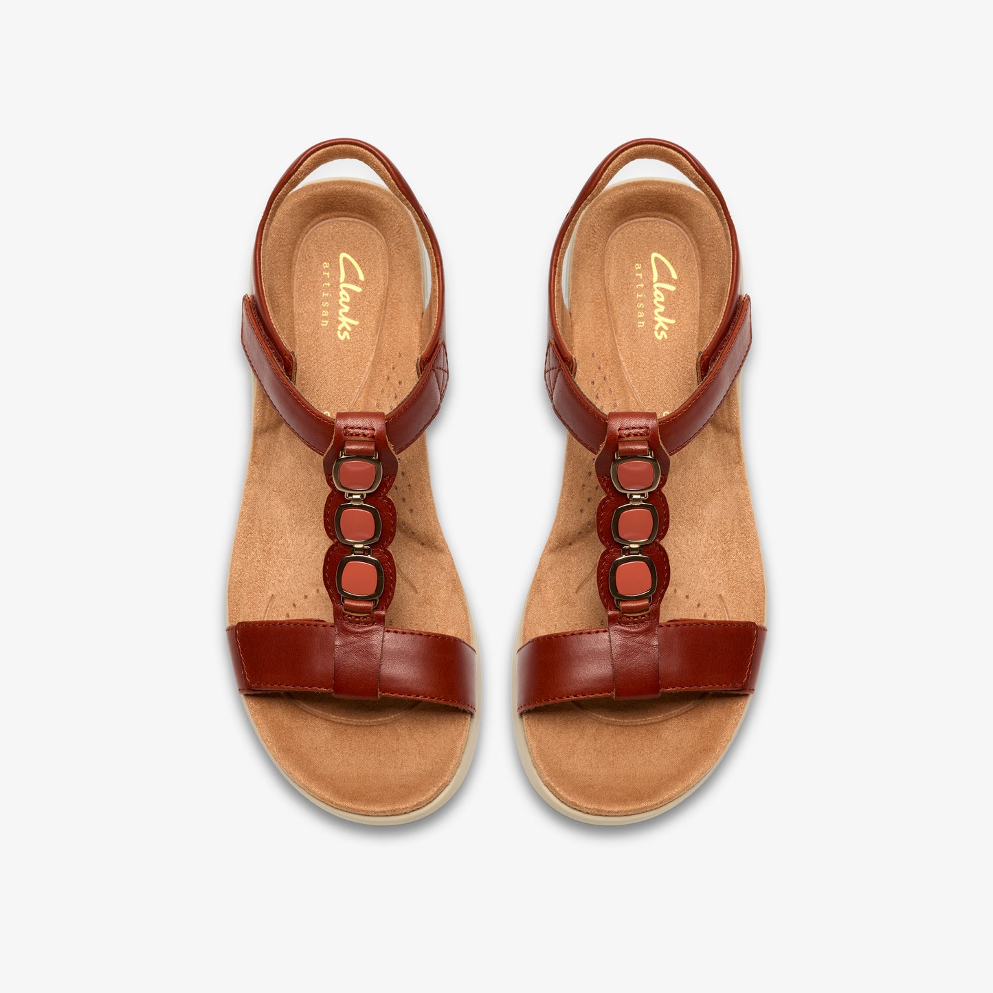 Pair of brown leather T-strap sandals with orange accents and velcro closures, seen from above.