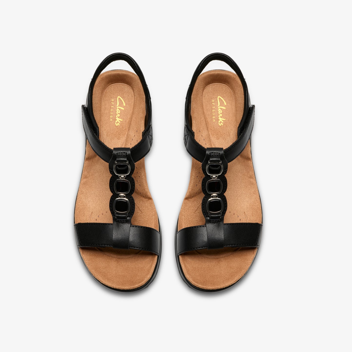 Pair of black leather sandals with three circular metal accents.