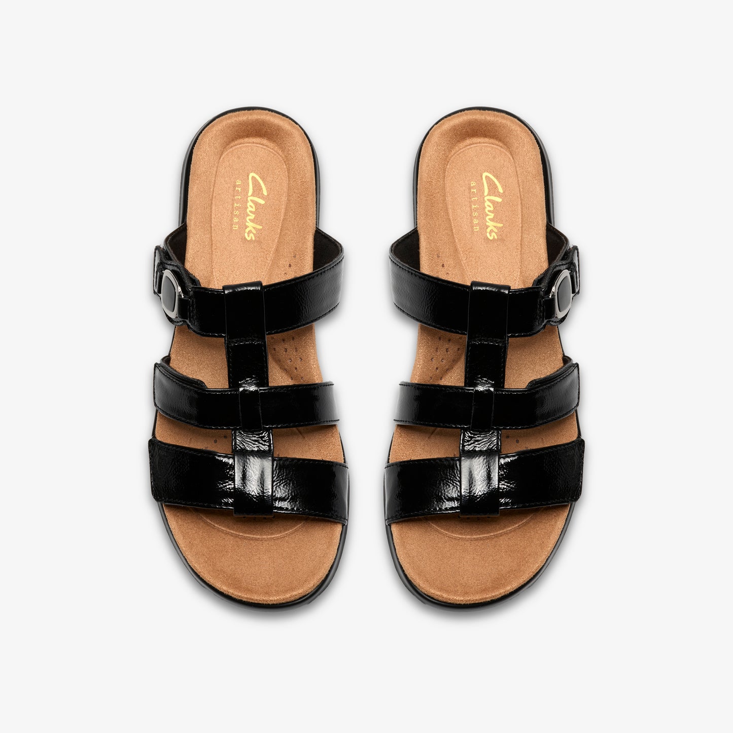 Pair of black patent leather sandals with adjustable straps.