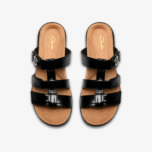 Pair of black patent leather sandals with adjustable straps.