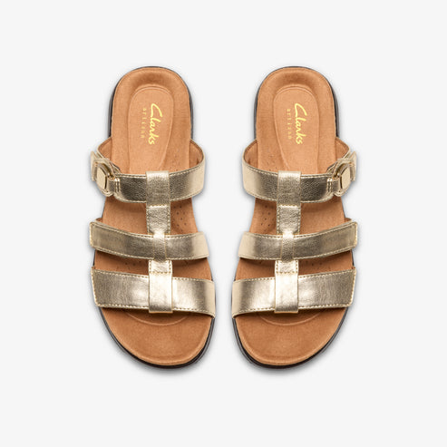 Overhead studio shot of metallic gold flat sandals with an adjustable buckled strap, t-strap, and two horizontal bands.