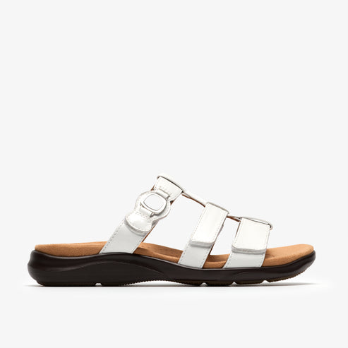 A white sandal with three adjustable straps and decorative accents.