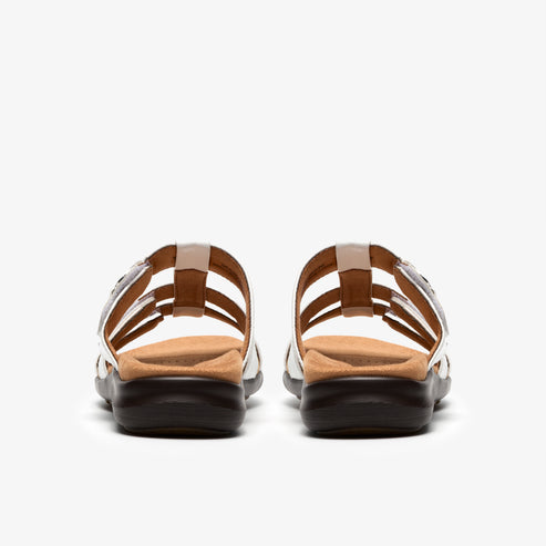 Pair of sandals seen from the back with multiple thin straps and dark soles.