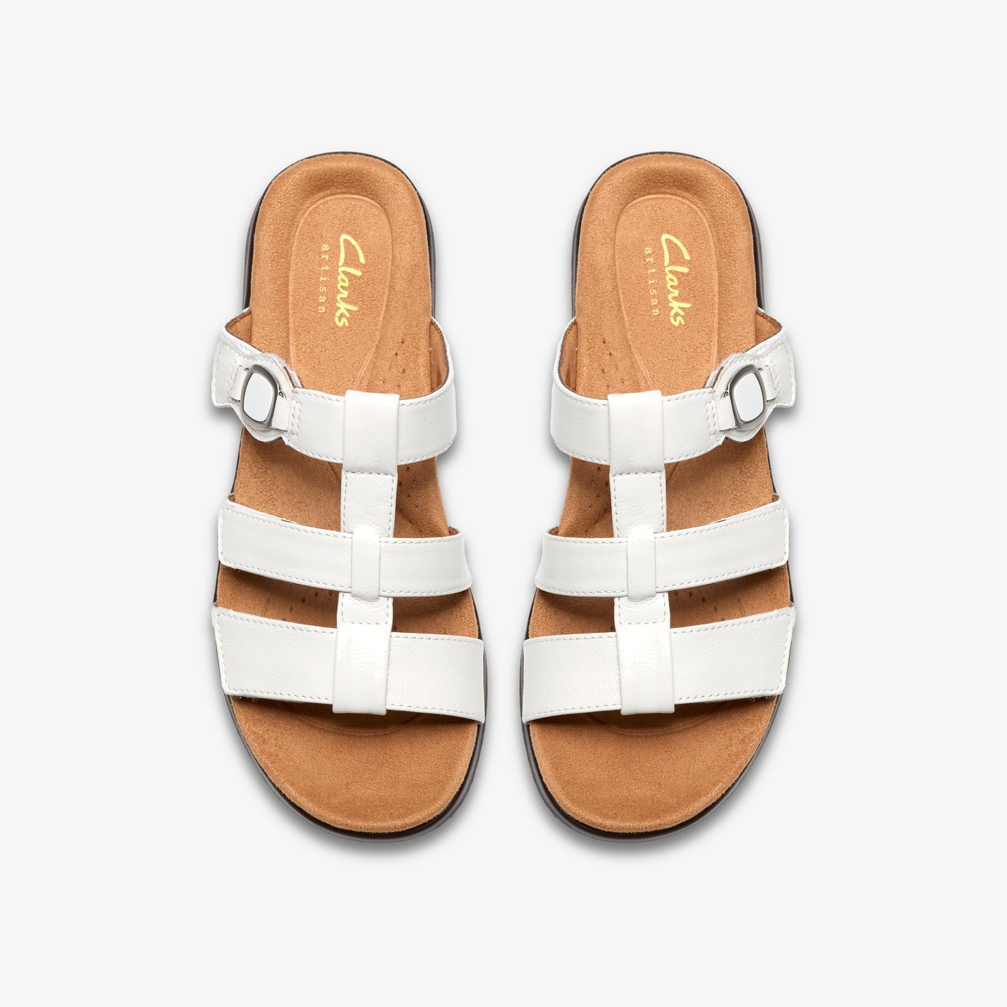 Top-down view of two white leather sandals, each with three straps and a brown insole marked with the word 'Clarks'.