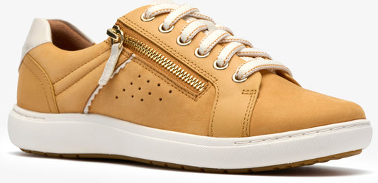 A tan sneaker with white laces and a gold zipper.