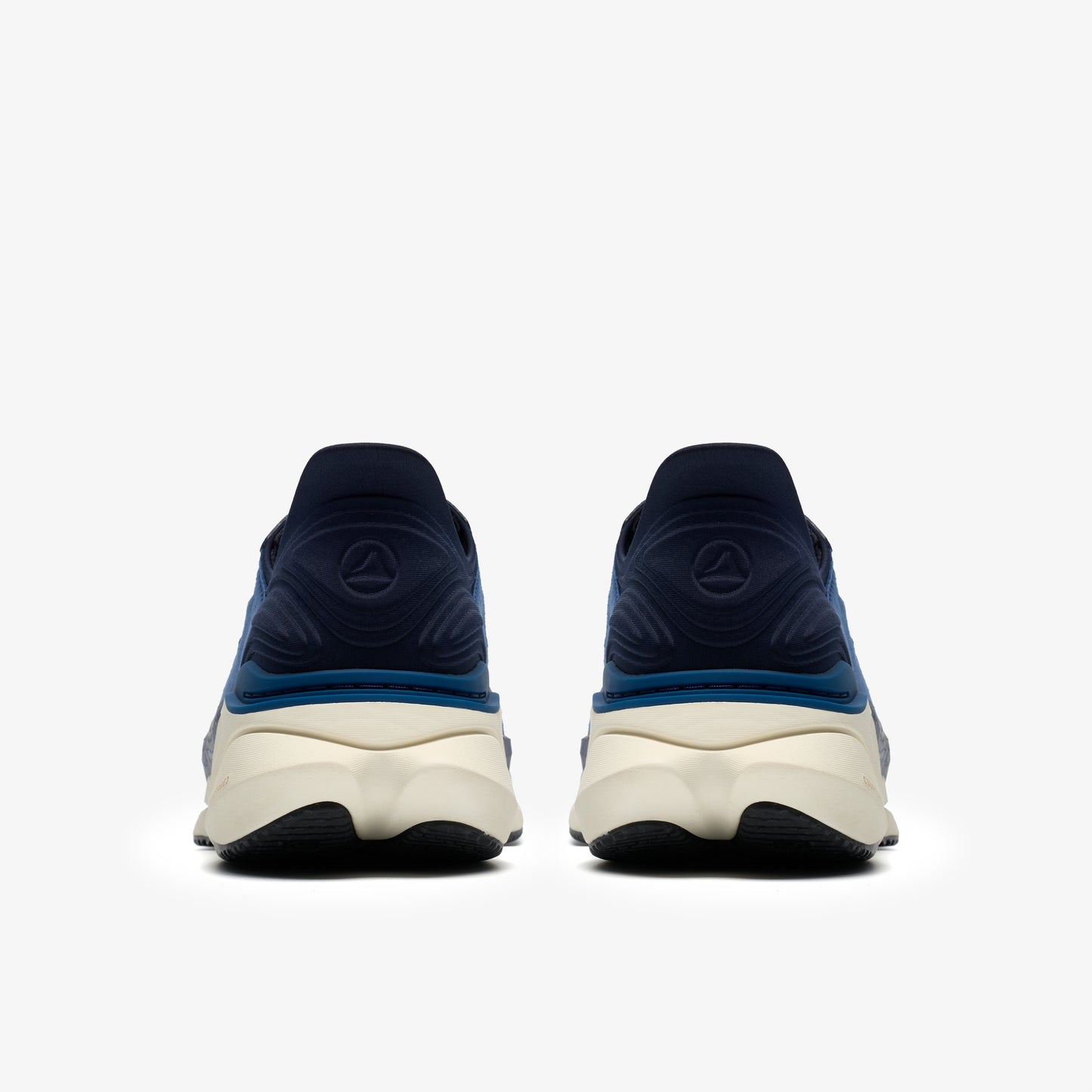 The back view of two navy and teal athletic shoes with white midsoles and black outsoles.