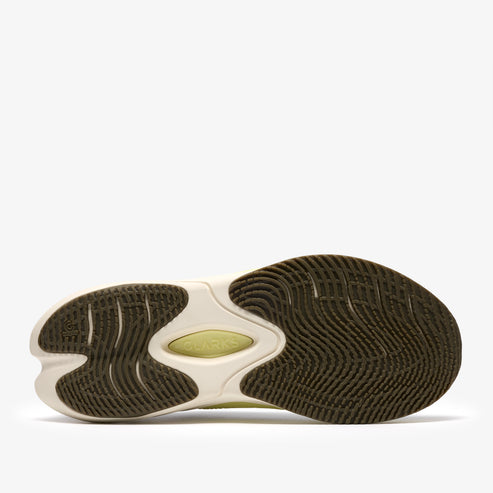 Bottom view of a green and off-white athletic shoe with a wavy tread pattern.