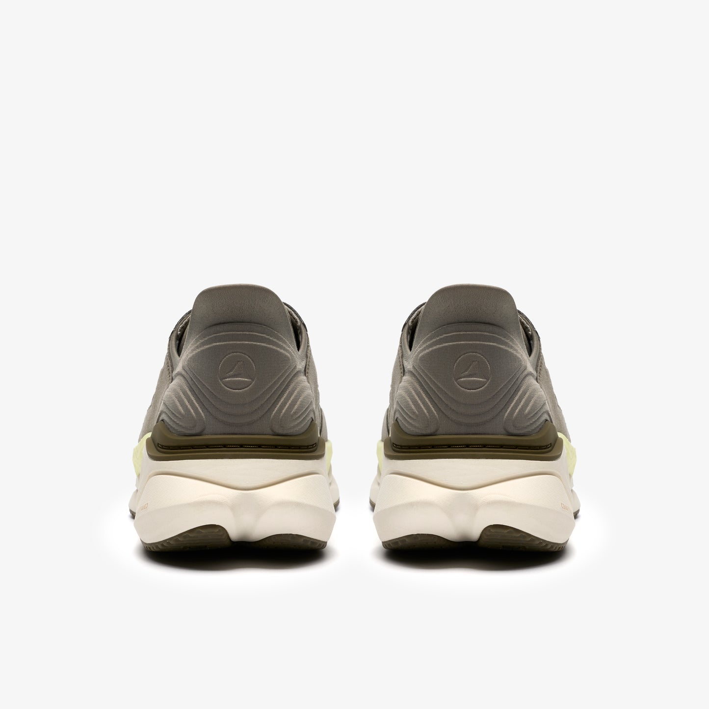 Pair of neutral running shoes, back view, demonstrating thick, cream-colored sole and logo on heel.