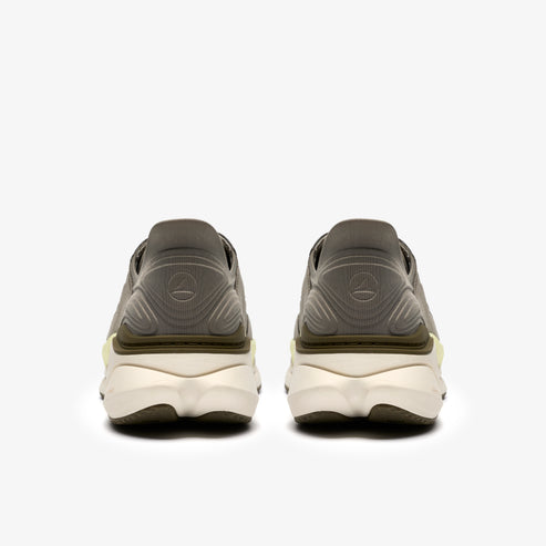 Pair of neutral running shoes, back view, demonstrating thick, cream-colored sole and logo on heel.