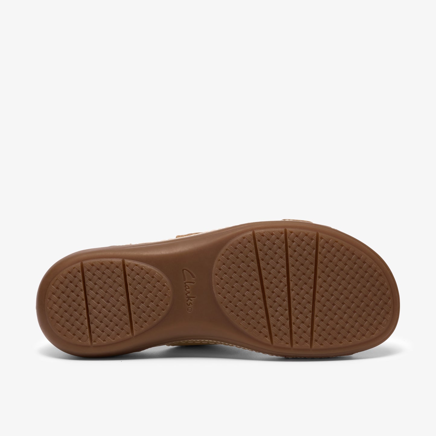 The sole of a brown sandal with a patterned, textured grip.
