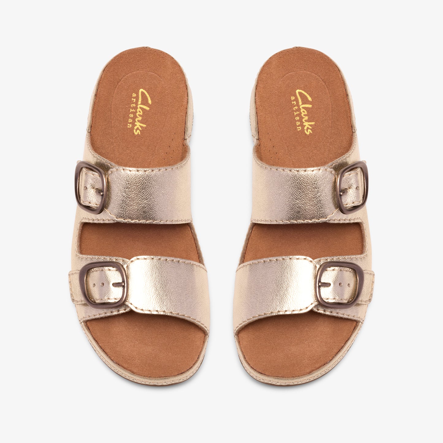 Pair of gold leather sandals with two straps and buckle closures.