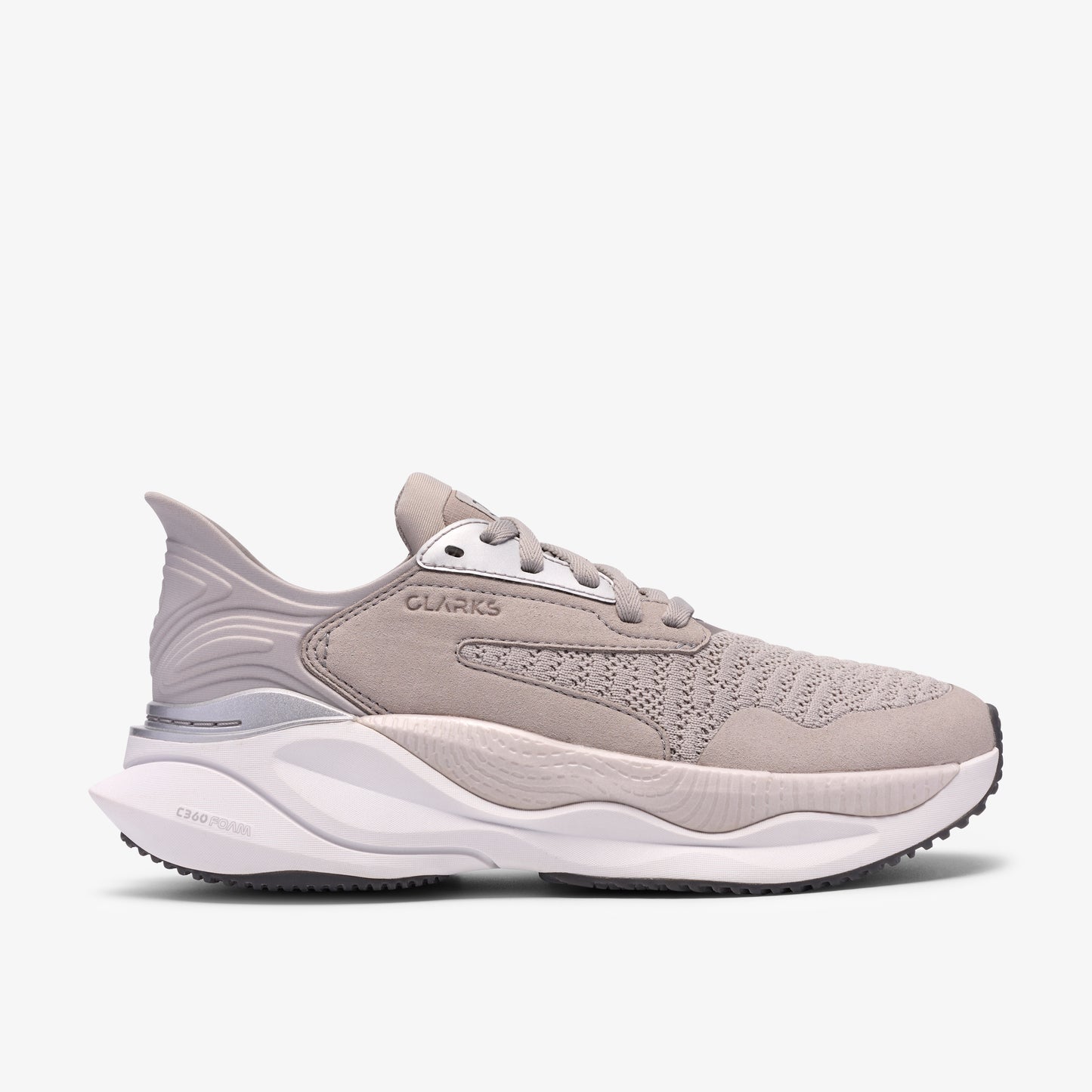Beige sneaker with a thick, white sole. "CLARKS" is displayed on the side.