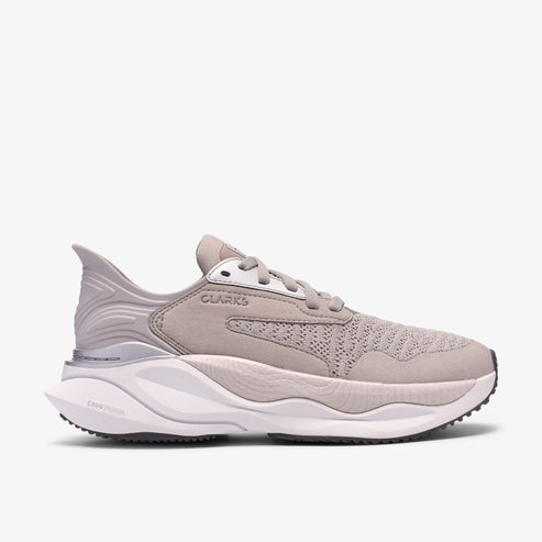 Beige sneaker with a thick, white sole. "CLARKS" is displayed on the side.