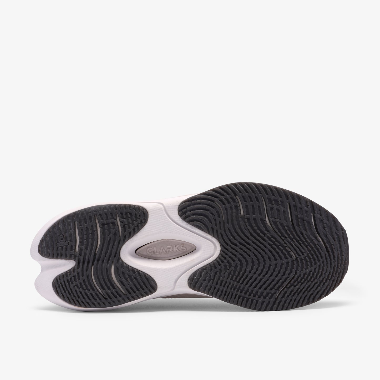 A shoe's black and white outsole with a logo in the center.