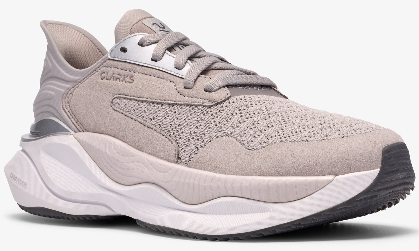 Low-top sneaker, light gray mesh upper, metallic silver accents, thick white and gray sole.