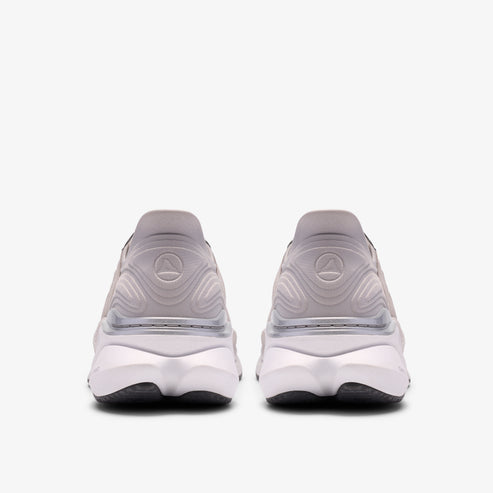 Rear view of two neutral running shoes, white with black soles.