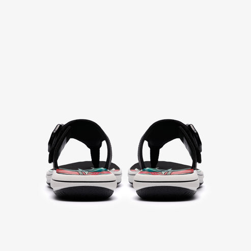 Two black sandals with floral designs, seen from behind.