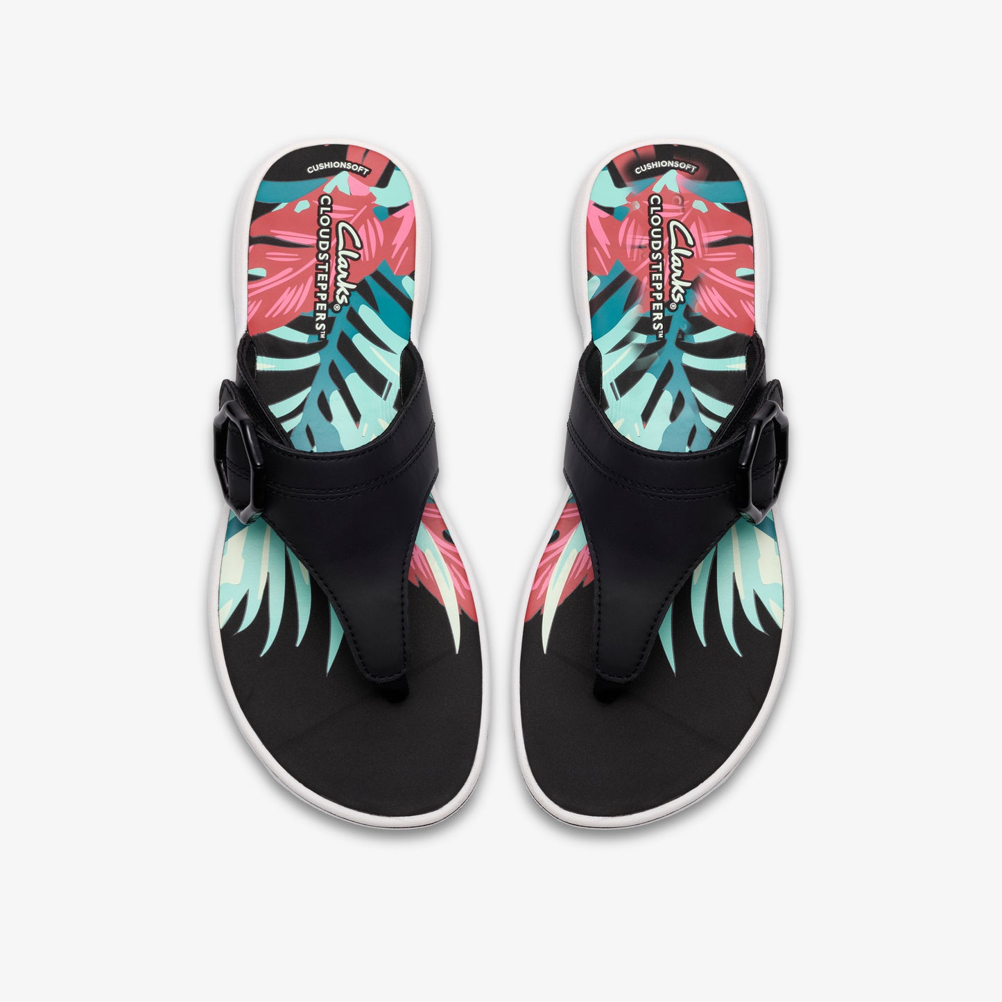 Overhead view of two black thong sandals with a buckle detail and a colorful tropical leaf design on the insole.