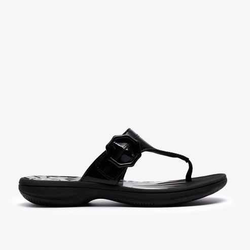 Black patent leather thong sandal with decorative buckle.