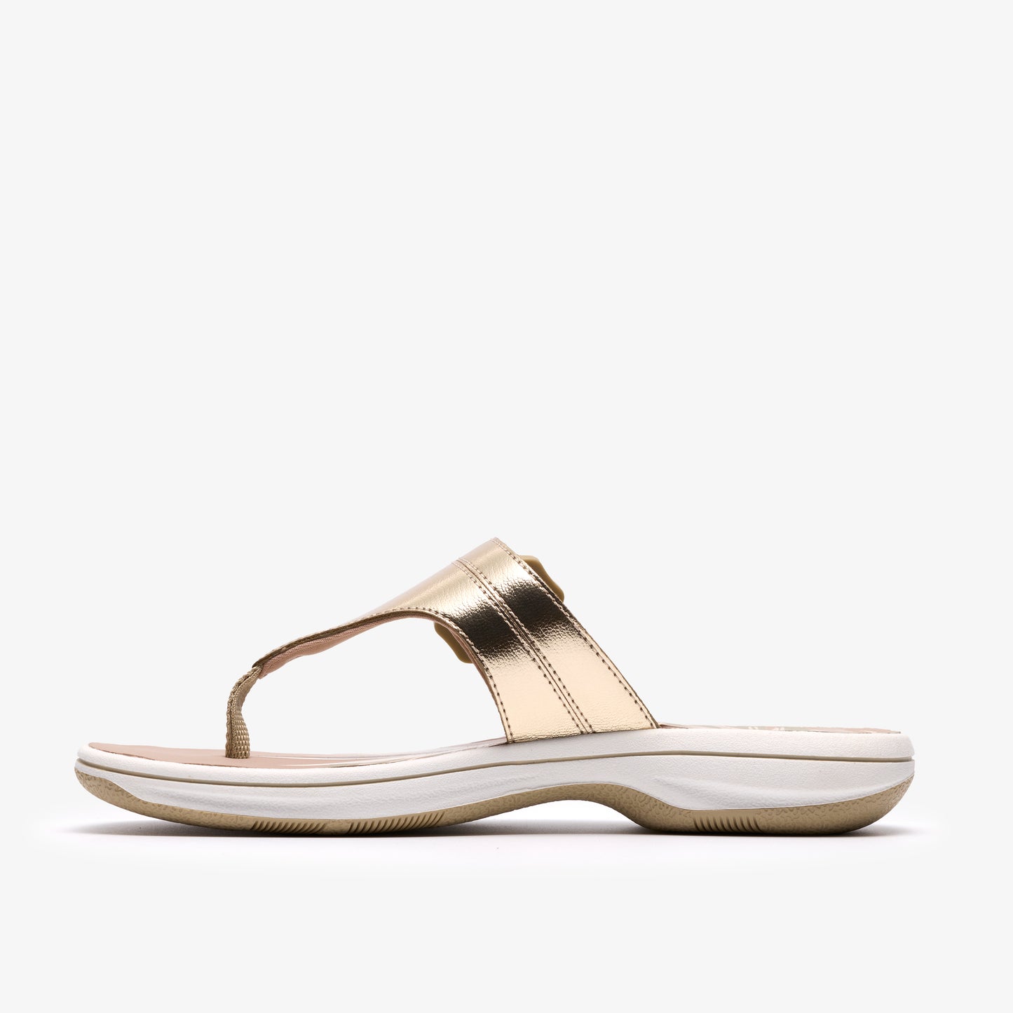 Gold metallic thong sandal with white sole, side view.