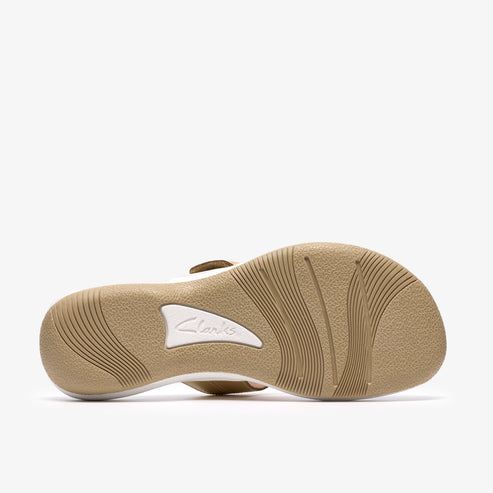 Sole of a sandal with tan treads and white logo.