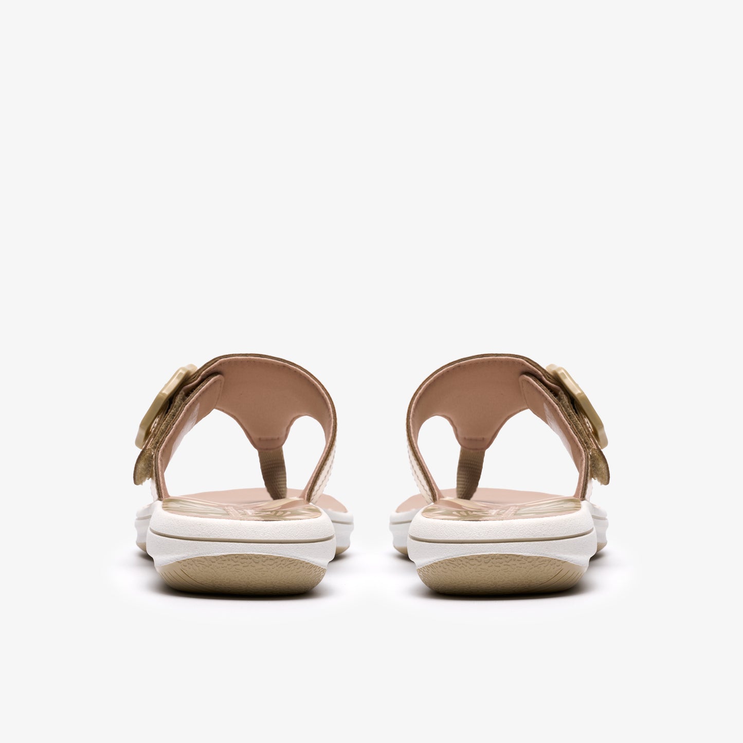 Pair of women's thong sandals, gold straps, flower buckle, white platform.
