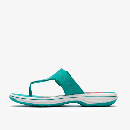 Turquoise sandal with a thong strap and a white sole.