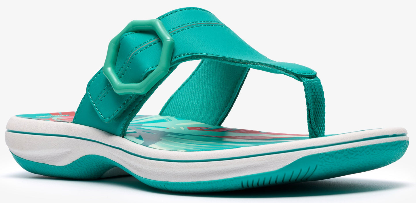 A turquoise sandal with a white sole.