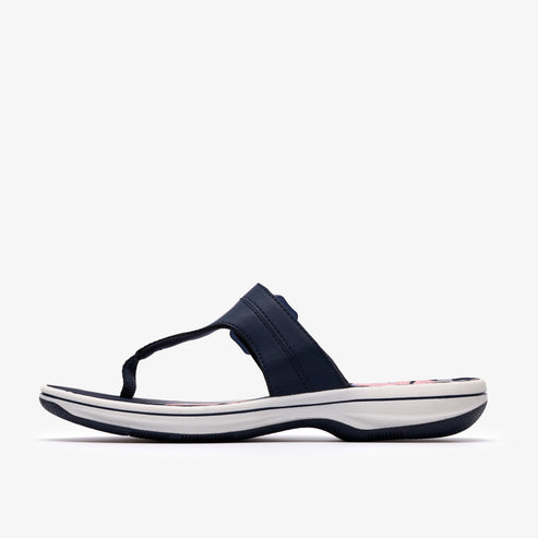 Navy blue flip-flop with a black toe post, a navy strap and a white sole.