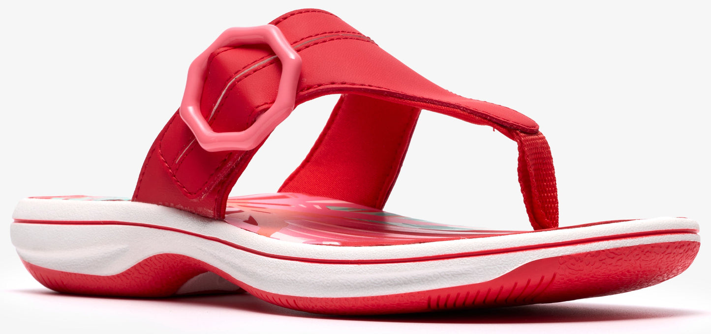Red flip-flop sandal with a thick band and a pale pink hexagonal buckle.