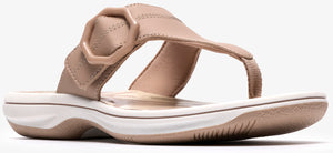 A beige sandal with a hexagonal accent.