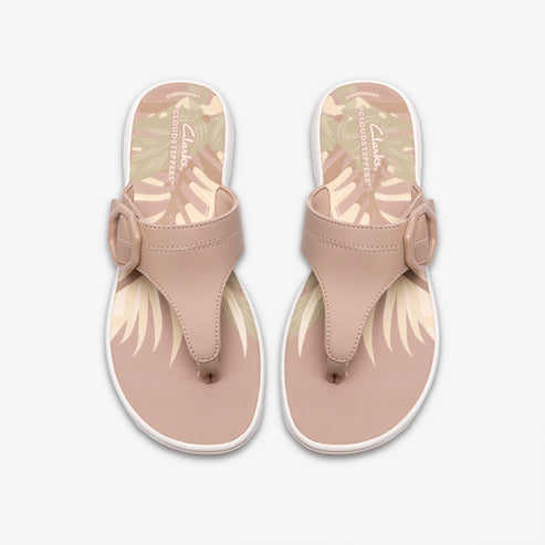 Pair of thong sandals with a buckle, blush pink straps and tropical leaf footbed.