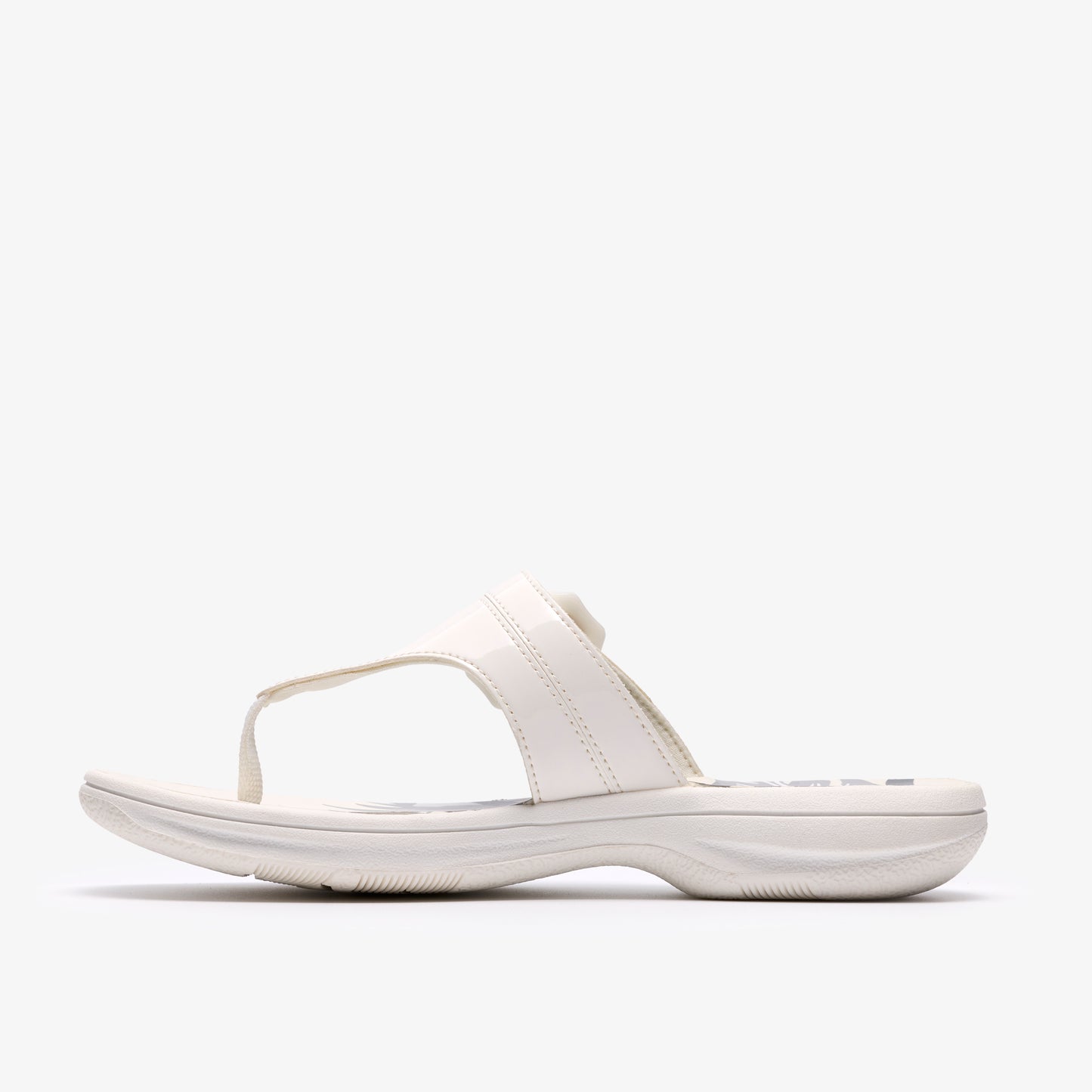 White sandal with toe post, slip-on style, and glossy straps.