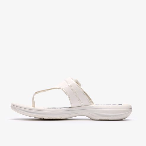 White sandal with toe post, slip-on style, and glossy straps.