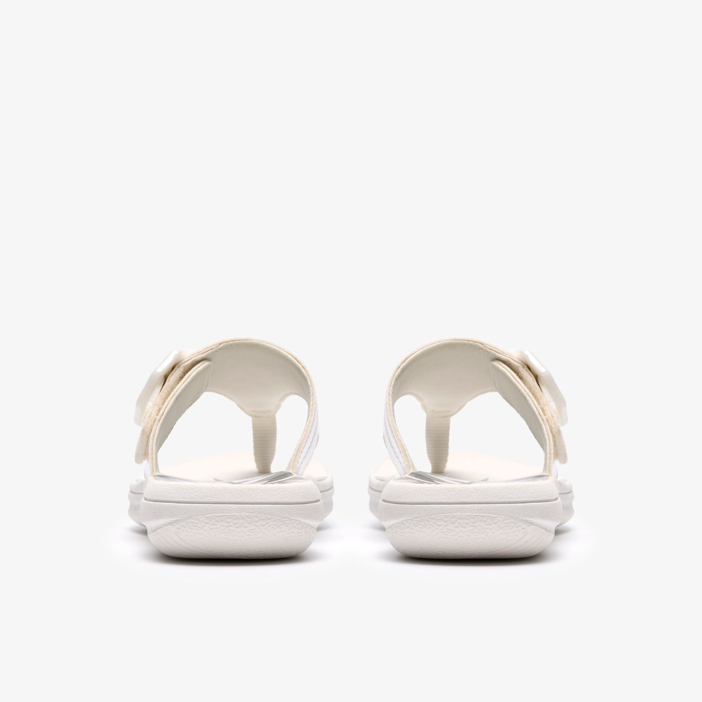 Pair of white flip-flops with flower detail from rear view.