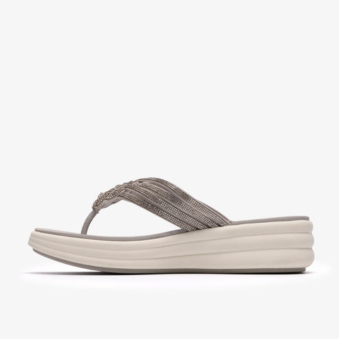 Side view of a taupe wedge flip-flop with beaded straps.