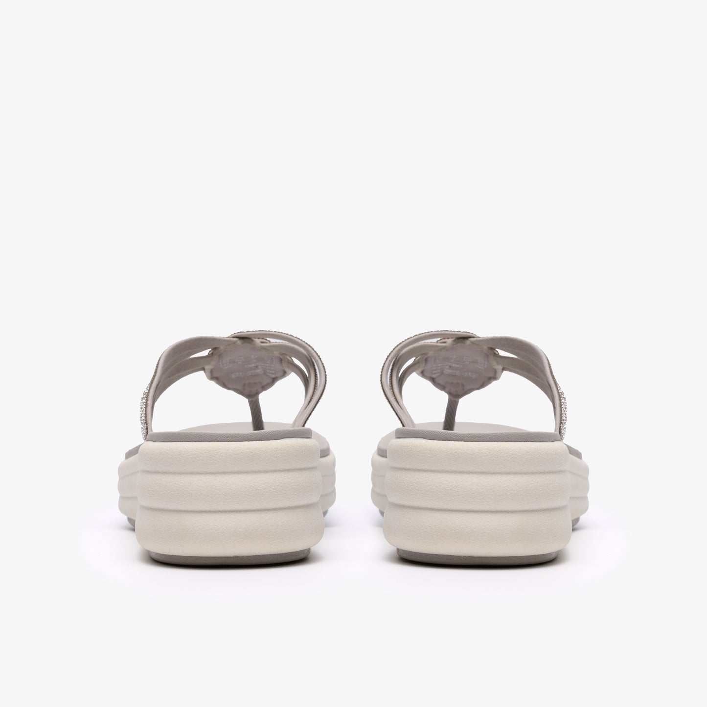 Pair of gray thong sandals with a platform sole, seen from the back.