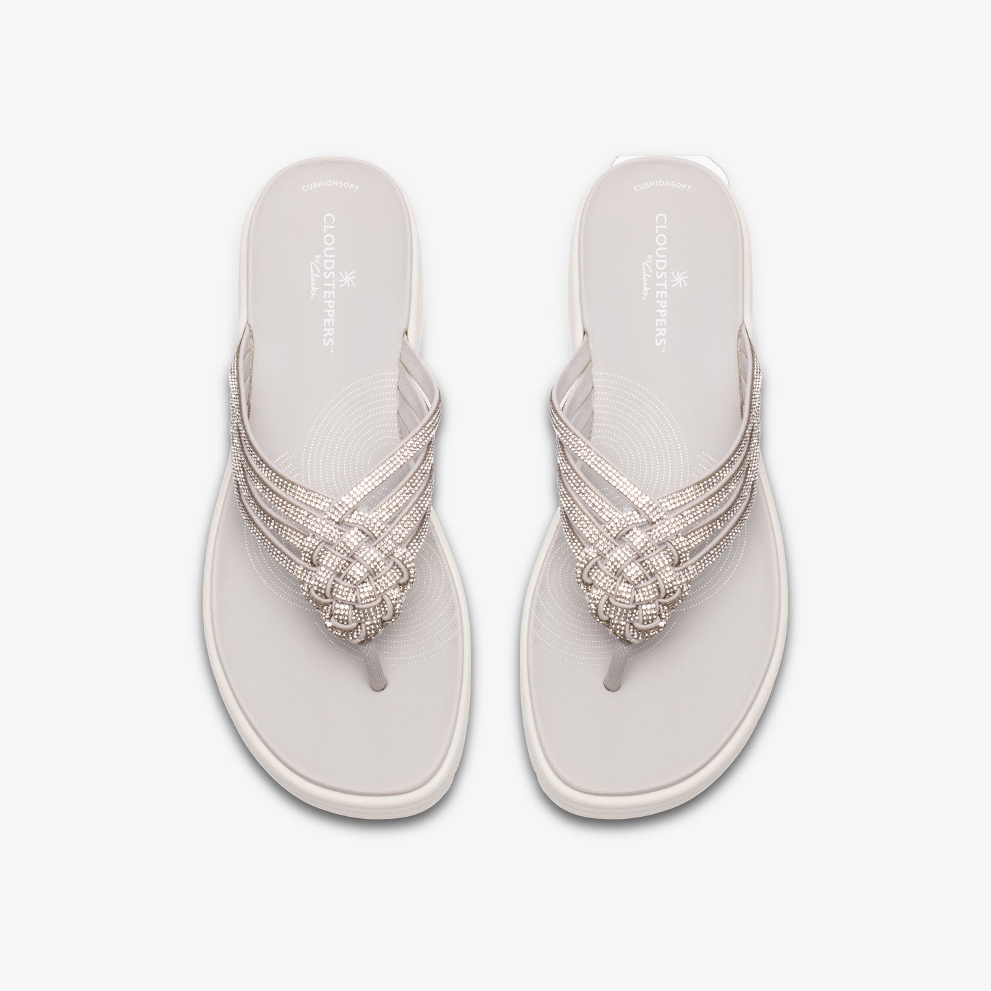 Pair of white flip-flops with woven straps.
