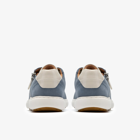 Rear view of two blue nubuck sneakers with white heel caps and soles. Sneakers are oriented front to back.