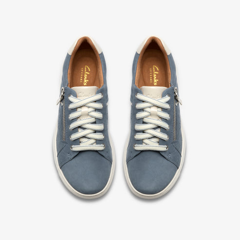 A pair of blue leather sneakers with white laces and a zipper on the side.