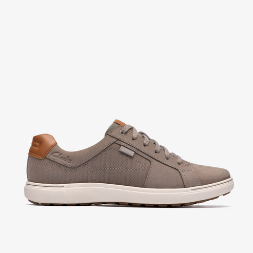 A gray canvas shoe with tan heel accent and a white sole.