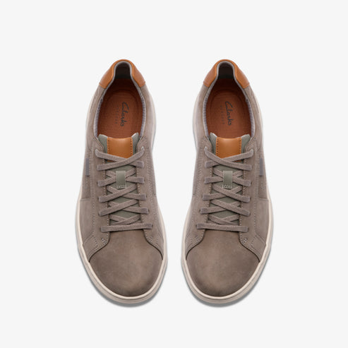 Pair of gray suede sneakers with tan accents, visible laces.