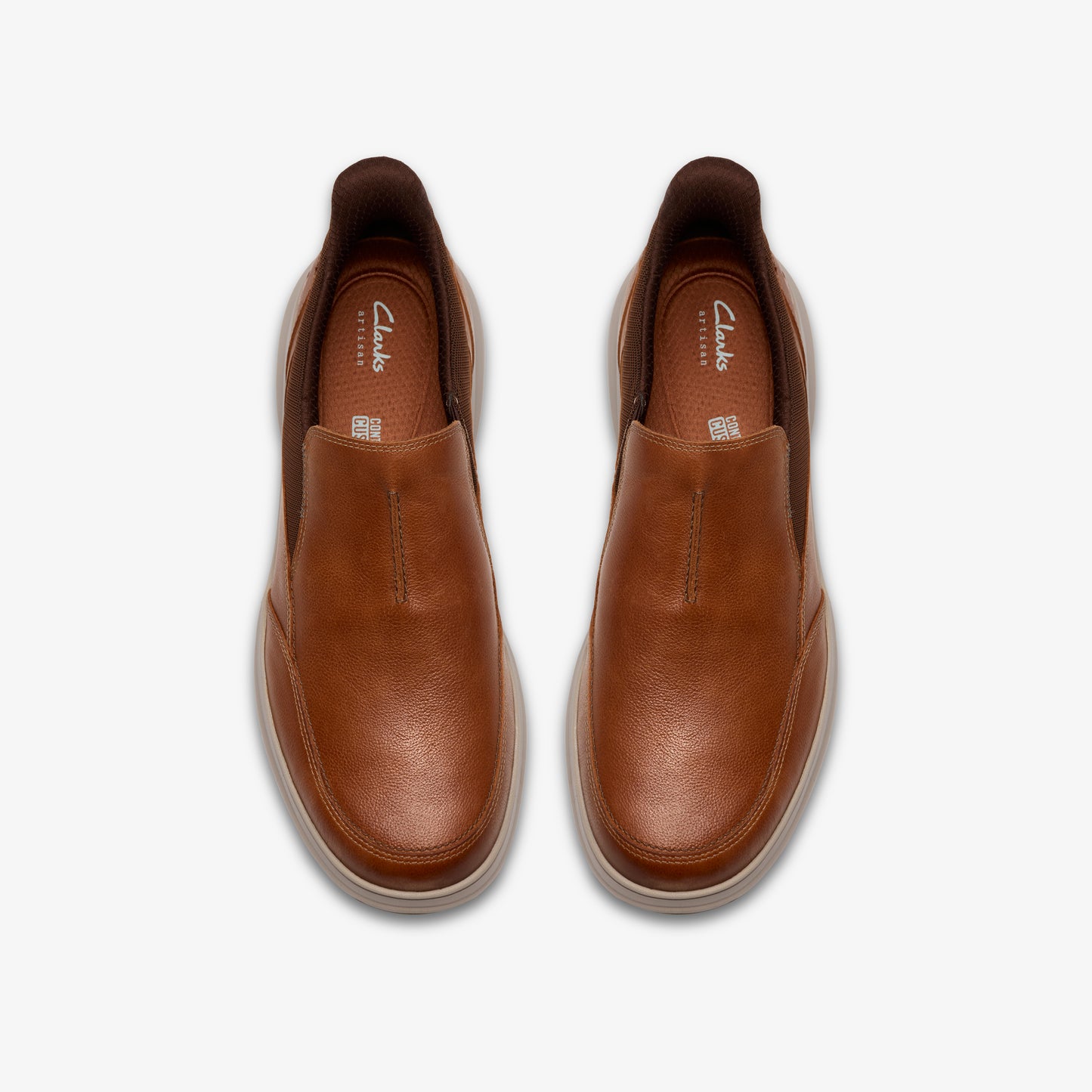 A pair of slip-on leather shoes in tan color.