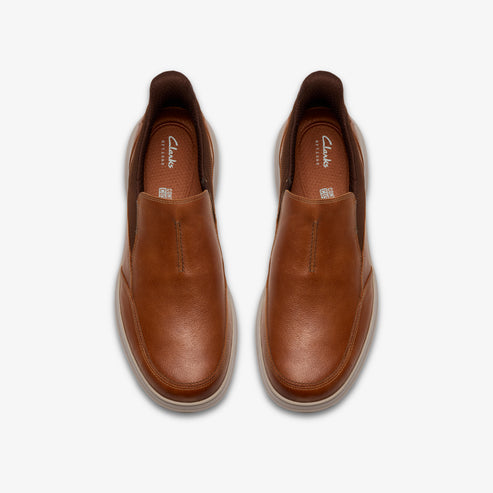 A pair of slip-on leather shoes in tan color.