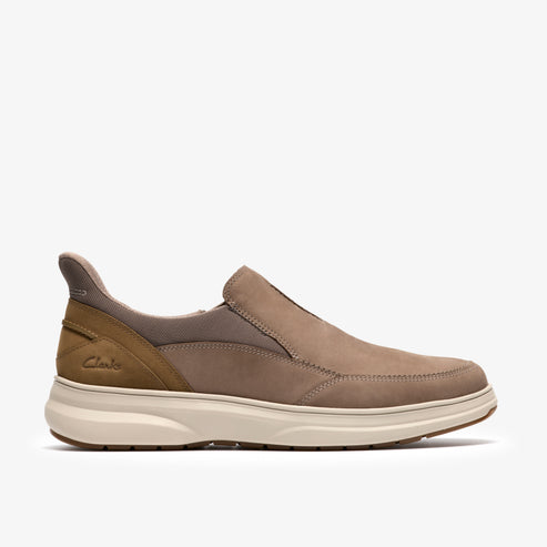 Tan slip-on shoe with tan accents and white sole; 'Clarks' brand visible on the side.