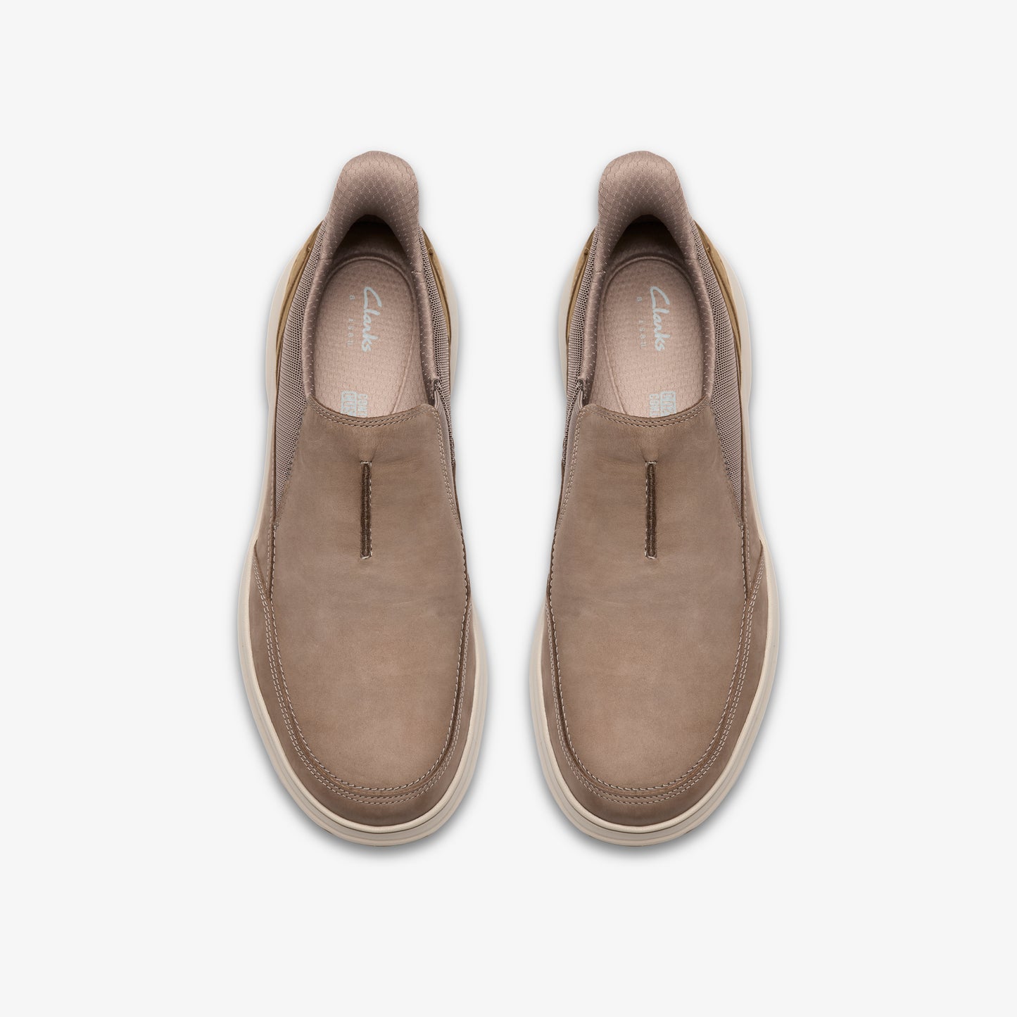 Top-down view of two taupe slip-on shoes with light-colored soles.