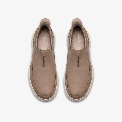 Top-down view of two taupe slip-on shoes with light-colored soles.